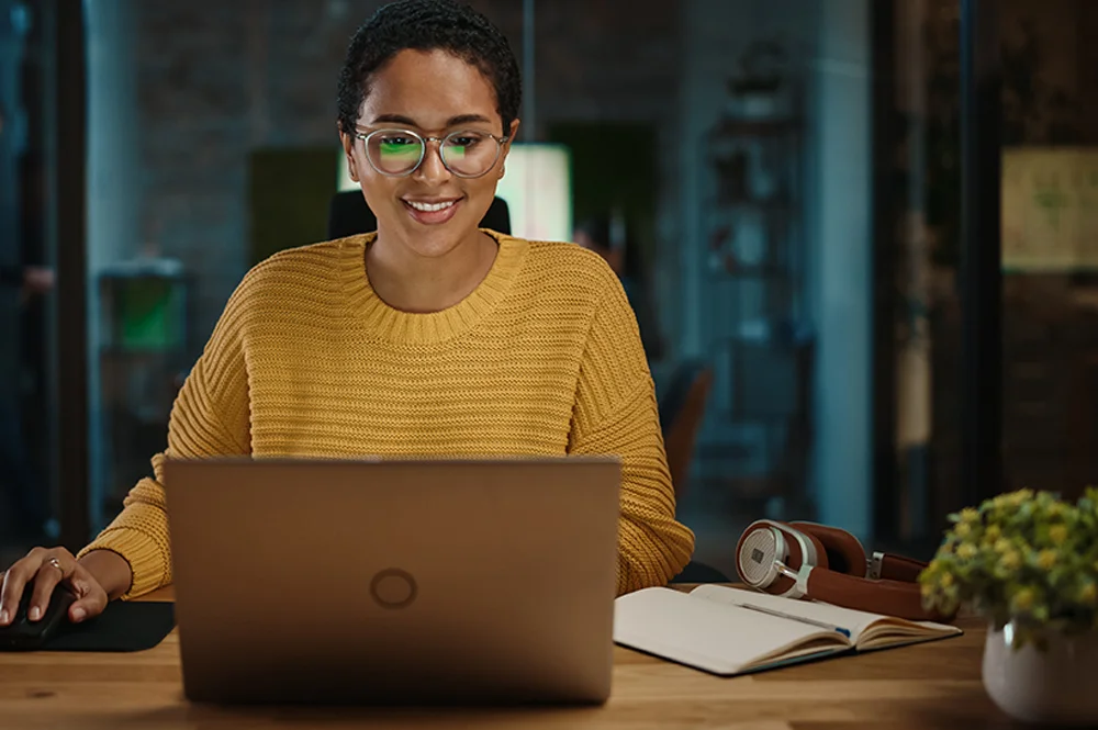 smiling woman at laptop working