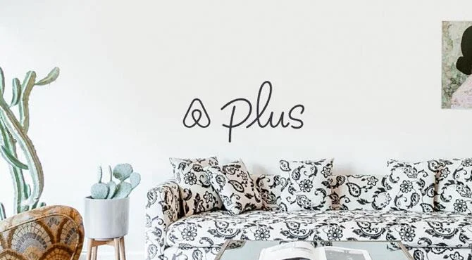 airbnb plus logo on wall about fancy white and black paisley sofa