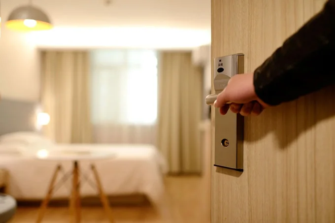 hand opening hotel room door