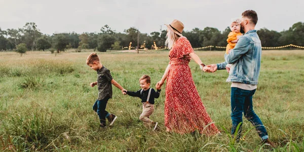 family walking through a meadow