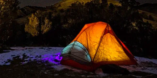 Night photo of a tent