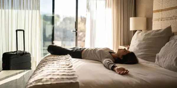 female traveler on hotel bed