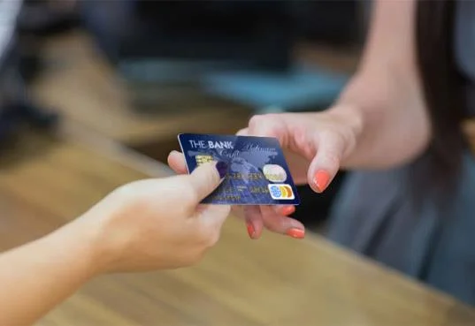 people exchanging a payment card