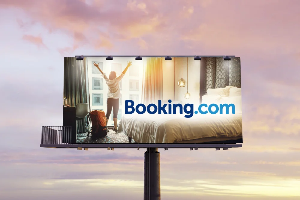 booking.com billboard with woman in hotel
