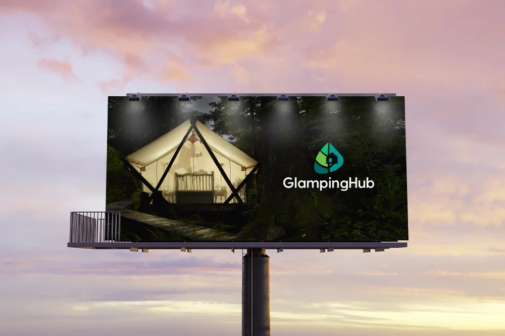 Billboard of triangle cabin with glamping Hub logo on it.