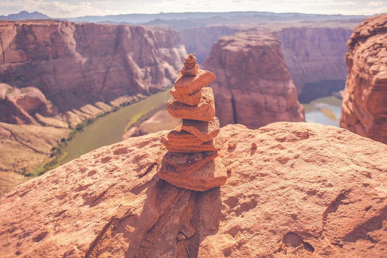 stones balanced on top of each other on a valley mountain top