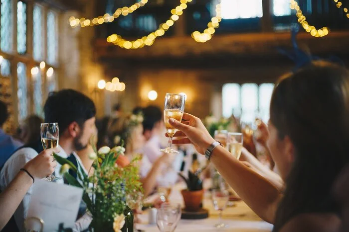 people holding up champagne for a toast