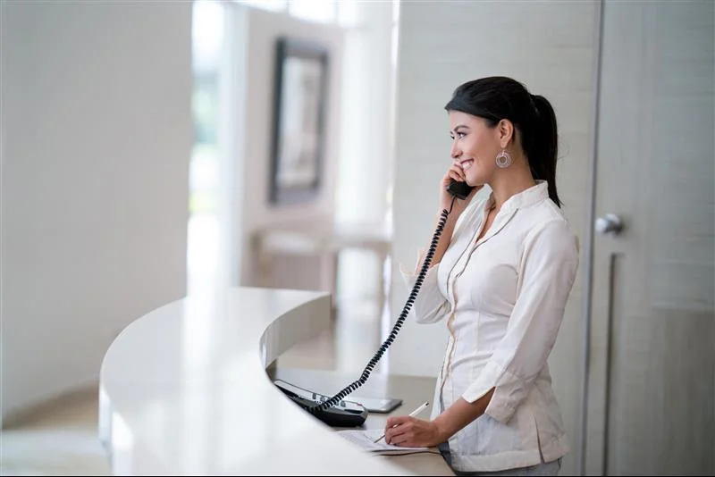 Hostess on the phone at the hotel