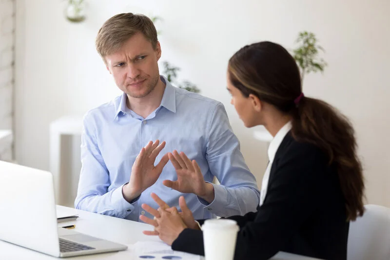 two people in an office arguing